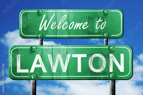 lawton vintage green road sign with blue sky background photo