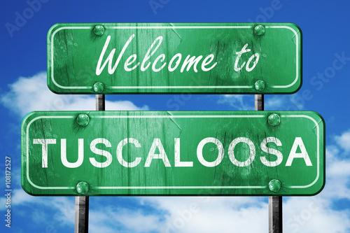 tuscaloosa vintage green road sign with blue sky background photo