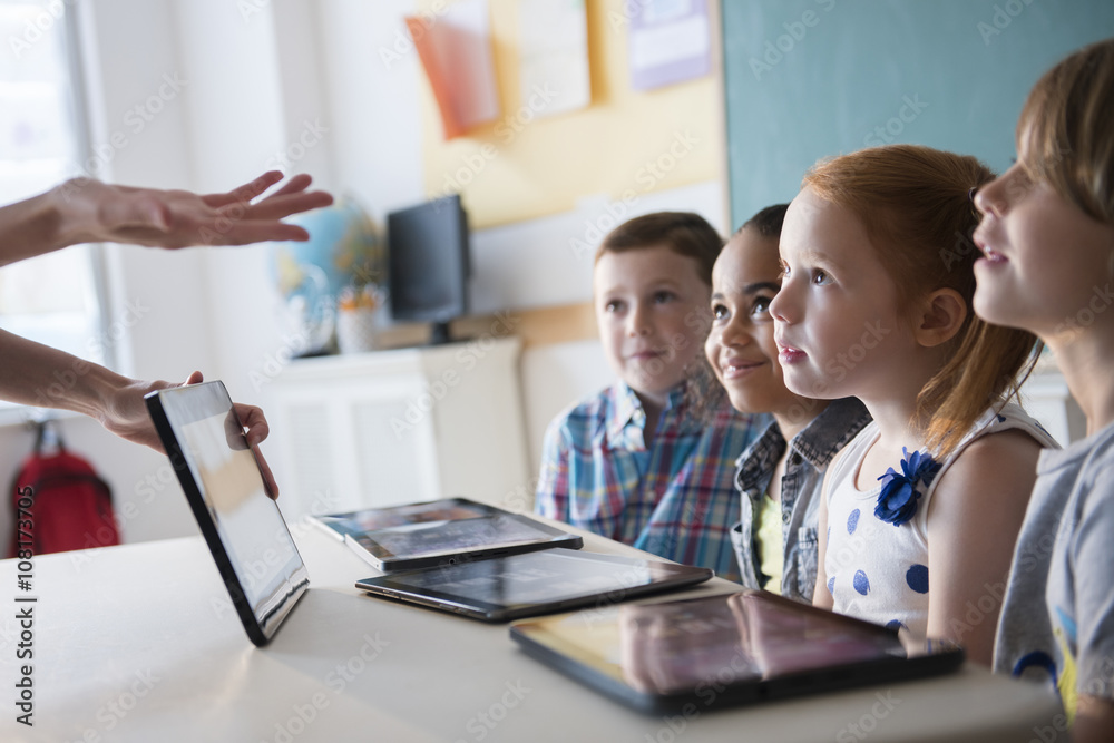 Teacher demonstrating tablet for students Teacher demonstrating tablet for students