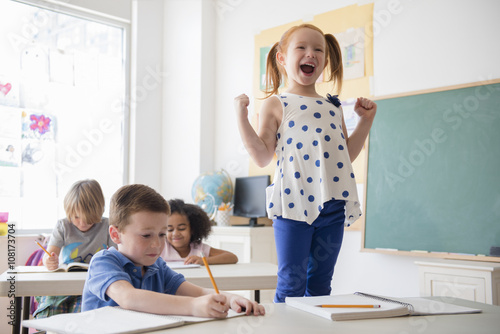 Student shouting at desk in classroom photo