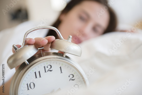 Native American woman turning off alarm