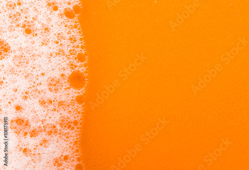 foam on orange background macro
