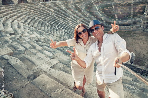Photography Couple in love take a selfie photo in ancient amphitheater in th