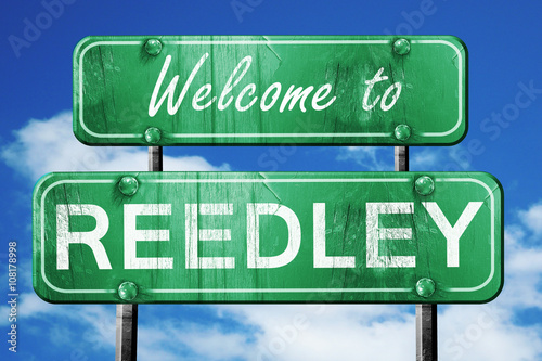 reedley vintage green road sign with blue sky background photo