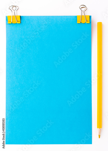 blue piece of paper with yellow paper clips and yellow pencil