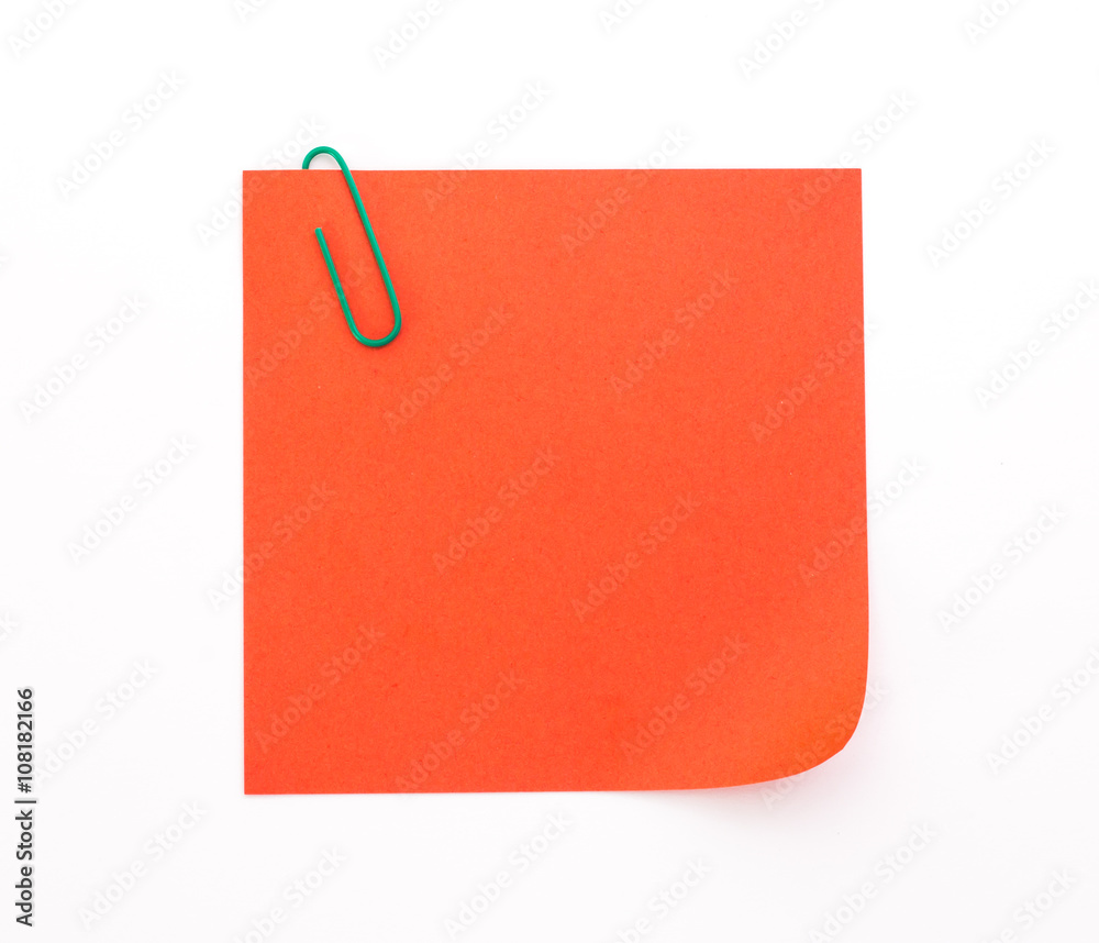 red sheet of paper with green paper clip on a white background red sheet of paper with green paper clip on a white background