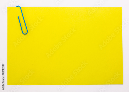 yellow sheet of paper with a blue clip photo