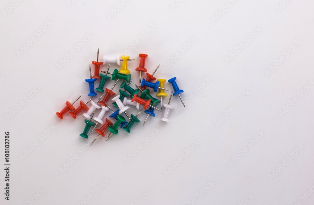colored push pins on a white background colored push pins on a white background
