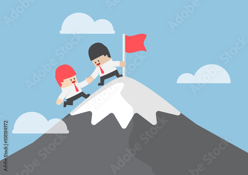 Businessman help his friend to reaching the top of mountain
