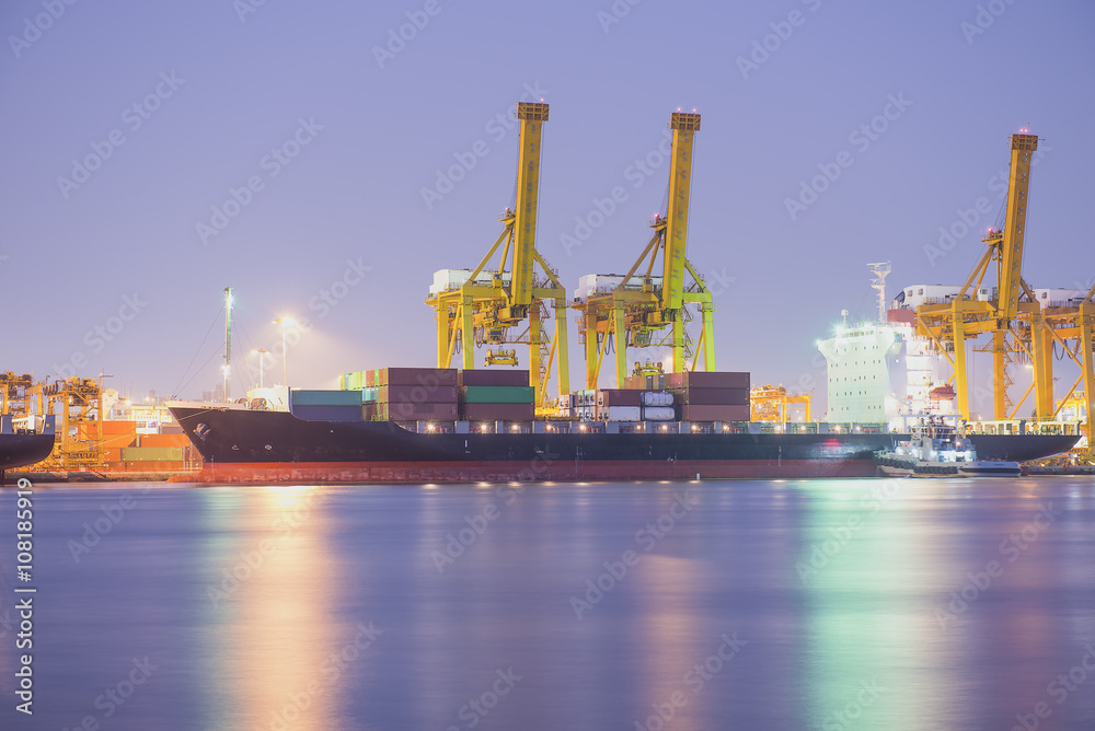 Container Cargo freight ship with working crane bridge in shipya