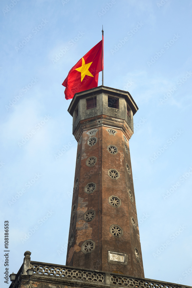 Ancient tower of the fortress with the Vietnamese flag. Hanoi, Vietnam