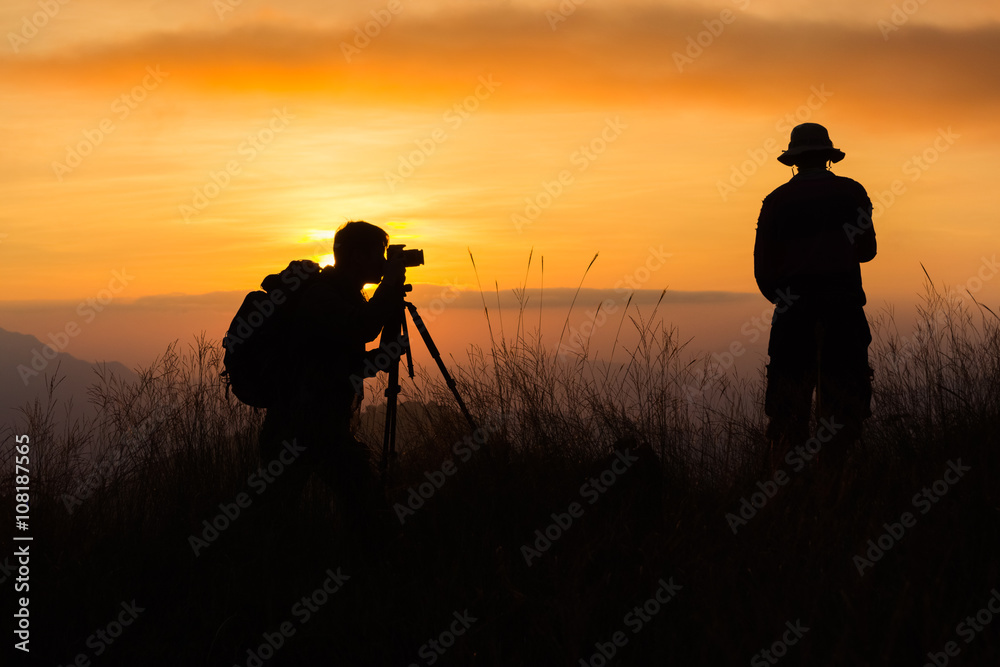 Silhouette of a young photographer during the sunset