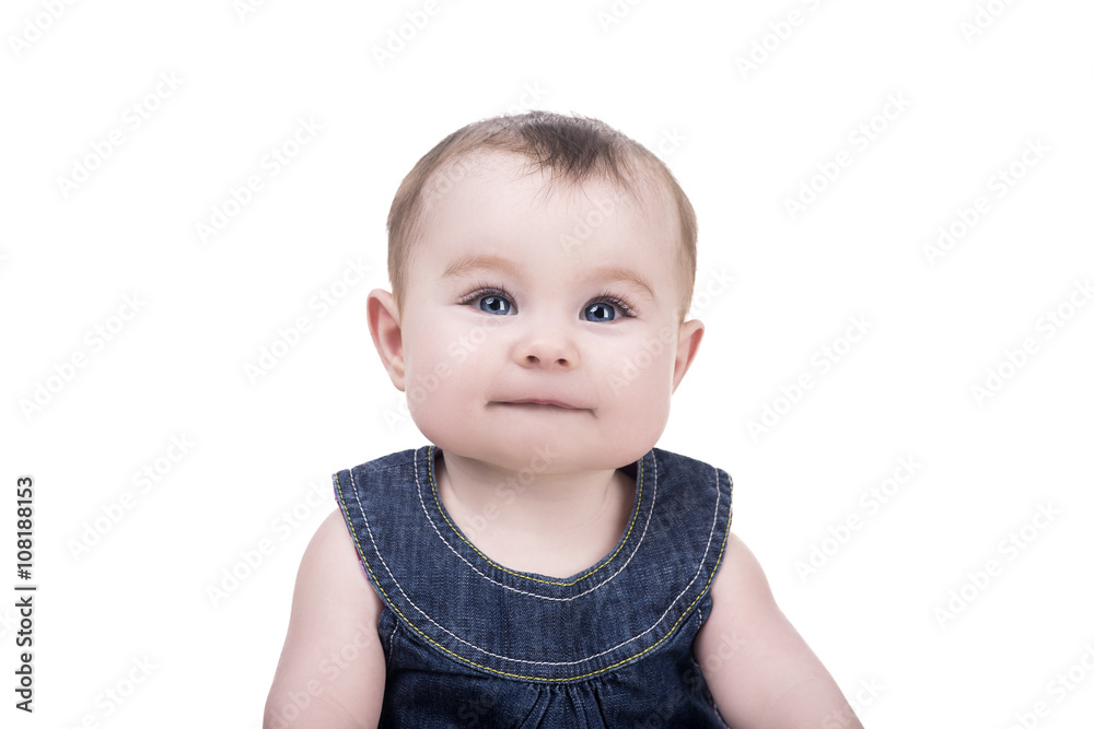 cute baby girl with blue eyes sitting and smiling. portrait of child on white background, isolated. baby looking front into the camera