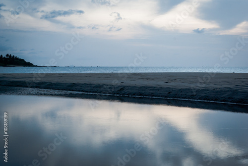 Seascape view with boat and beach in sunrise time with refection on water with the sky  Thailand beach.