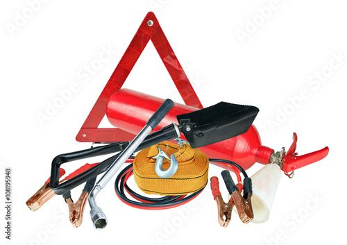 Elements of the essentials for a passenger car. Danger Safety Warning Triangle Sign, towing rope, fire extinguisher, Jumper cable, wheel wrench and shovel. photo