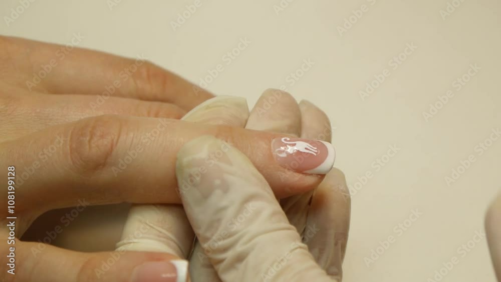 Manicure nail care in a beauty salon. Cat designs Manicure nail care in a beauty salon. Cat designs