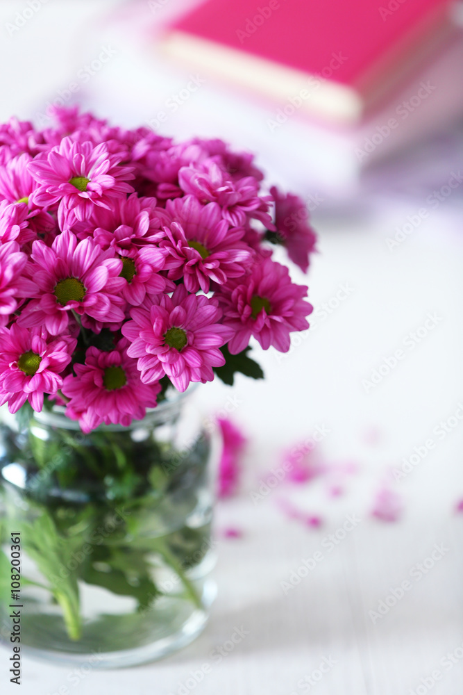 Beautiful flowers in vase on table in room Beautiful flowers in vase on table in room