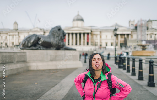 London tourist woman on Trafalgar Square in front of National Gallery smiling happy laughing having fun. Beautiful girl on travel vacation, London, England, United Kingdom. © Daniel