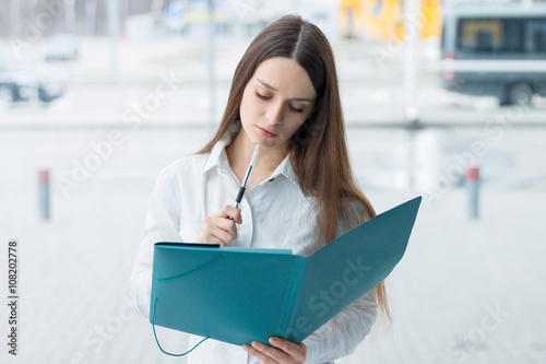 Friendly business woman holding folder