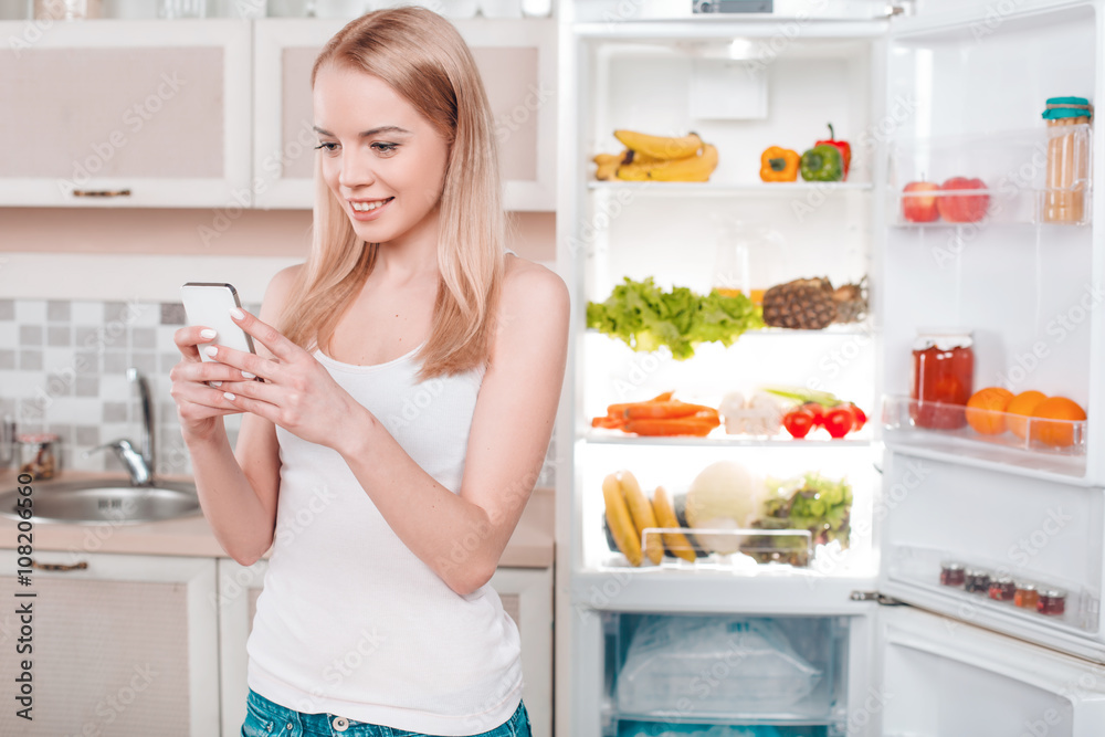 Young blonde at home near fridge Young blonde at home near fridge
