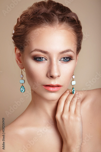portrait of the beautiful young girl in an image of the bride with ornament in hair.Beautiful Professional Holiday Make-up.Glamorous Woman
