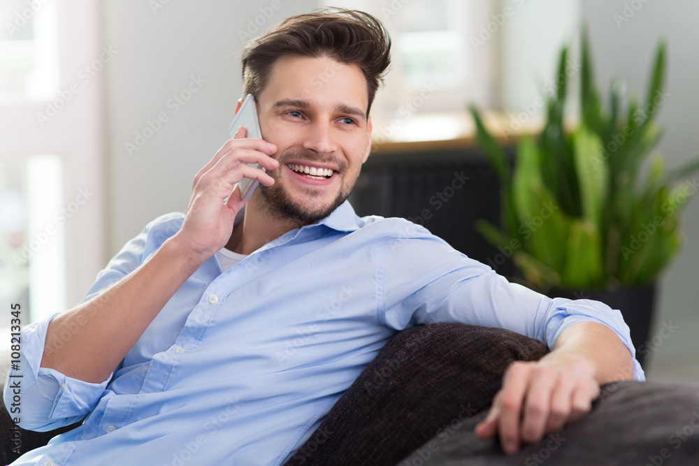 Man using mobile phone at home Man using mobile phone at home