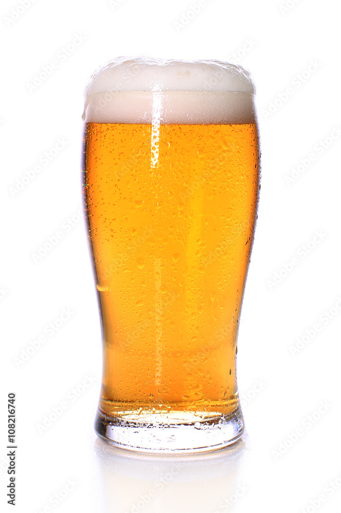 Light cold beer in a glass glass on a white background Light cold beer in a glass glass on a white background