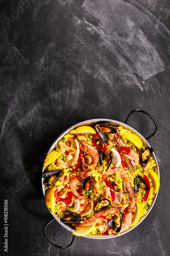 Colorful Seafood Paella Dish on Chalkboard Surface