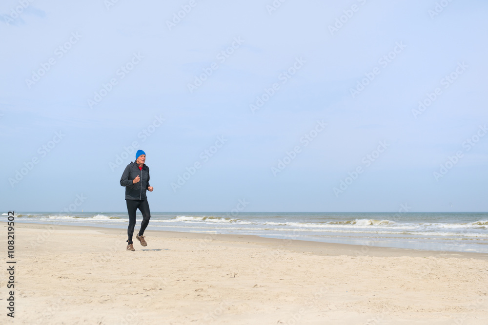 Senior man running at beach