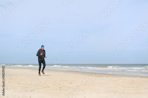 Senior man running at beach