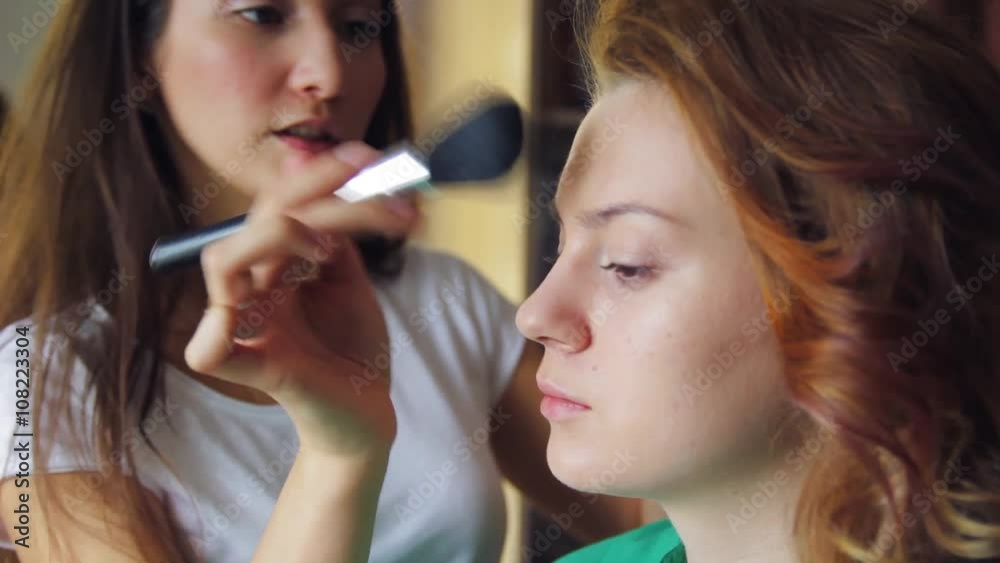 In the beauty salon, make-up artist doing make-up, hairdresser doing hairstyle, beautiful models In the beauty salon, make-up artist doing make-up, hairdresser doing hairstyle, beautiful models