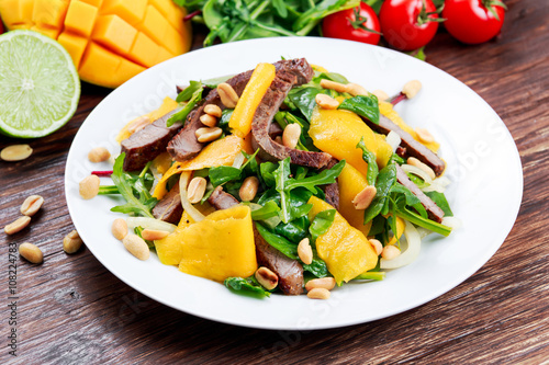Fresh Tasty Mango, beef salad with vegetables and nuts.