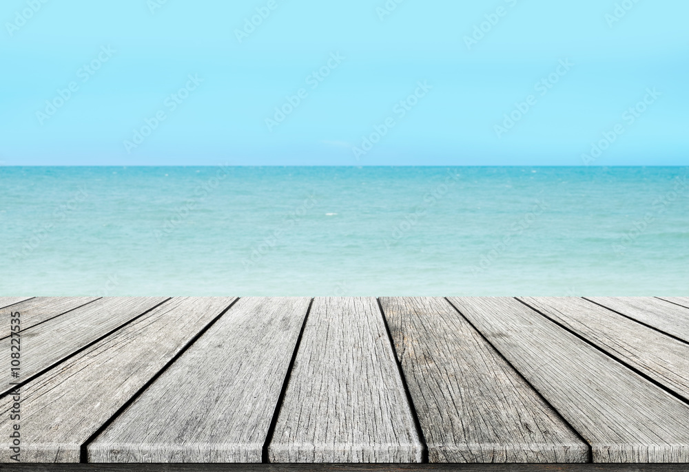 old wood table top on blurred beach background / summer concept