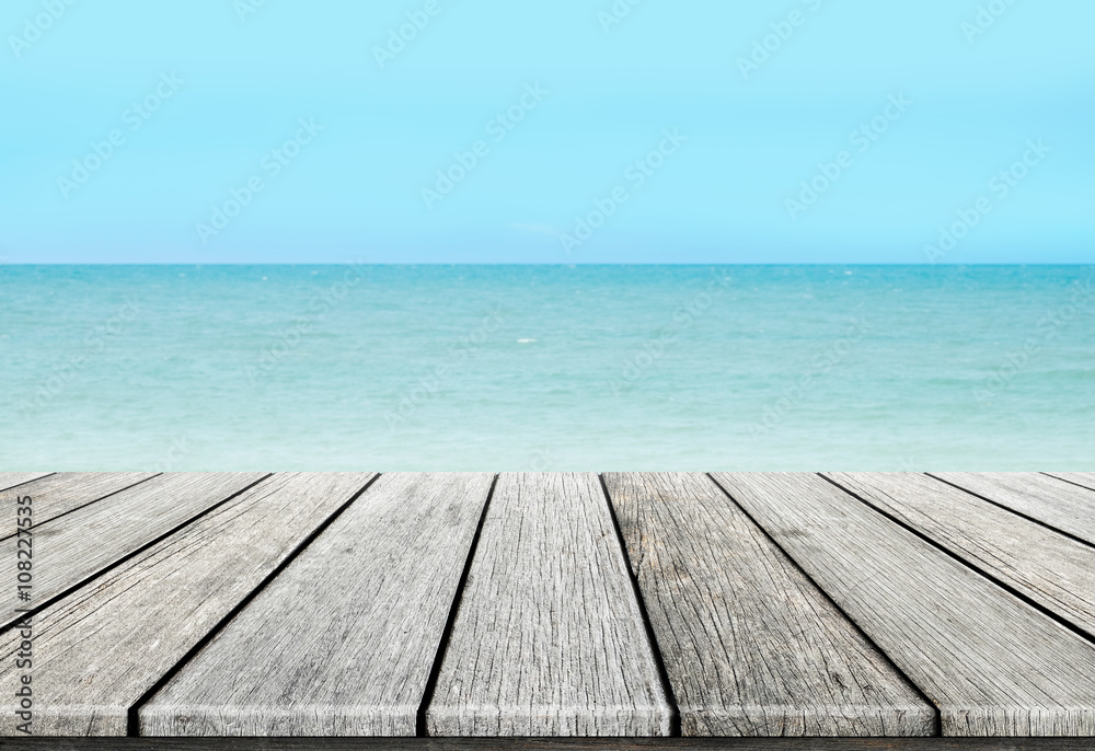 old wood table top on blurred beach background / summer concept old wood table top on blurred beach background / summer concept