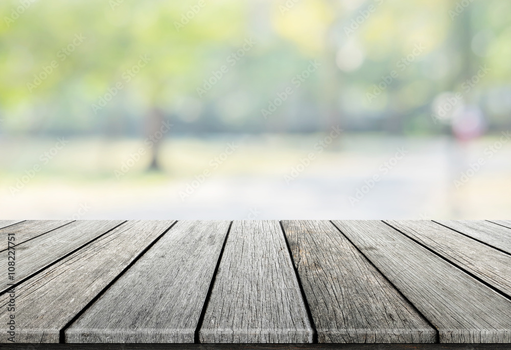 Empty wooden table with blurred city park on background, natural background with bokeh / spring concept