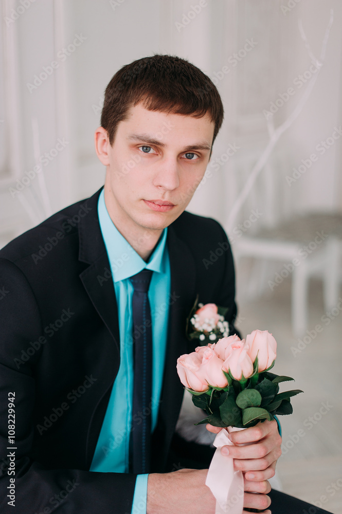 Full body portrait of young stylish businessman in tie and vest with hands on waist Full body portrait of young stylish businessman in tie and vest with hands on waist