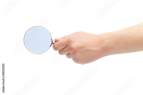 Magnifying glass in a hand