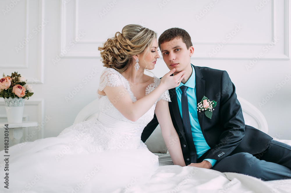 Happy couple. Wedding photo shoot in the white studio with wedding decor kisses, hugs