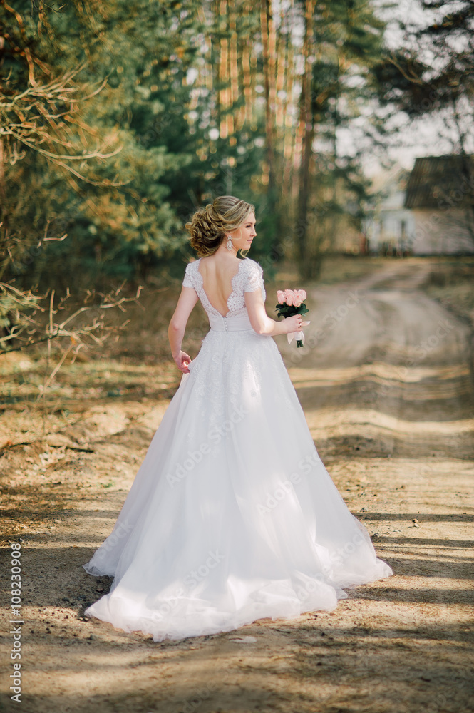 Beautiful bride woman portrait with bridal bouquet posing in her wedding day