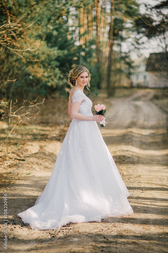 Beautiful bride woman portrait with bridal bouquet posing in her wedding day