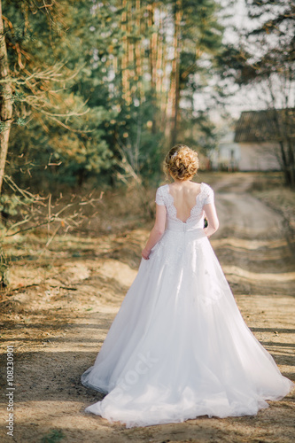 Beautiful bride woman portrait with bridal bouquet posing in her wedding day