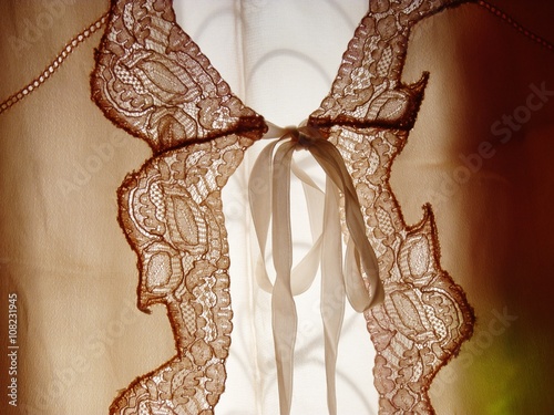 antique lace and ribbon blouse on a clothing rack