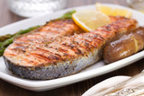 grilled salmon with lemon and vegetables on dish