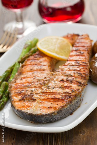 salmon with lemon and vegetables on white dish