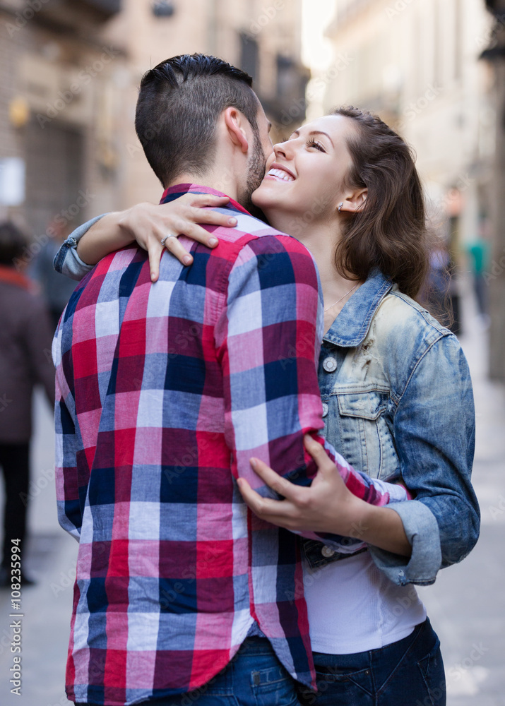 Happy woman hugging her male