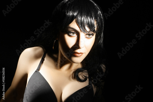 Brunette woman portrait on black