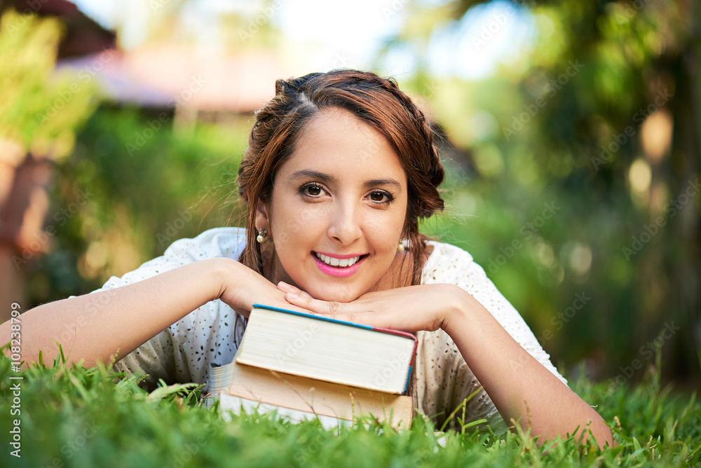 girl lay on top of books