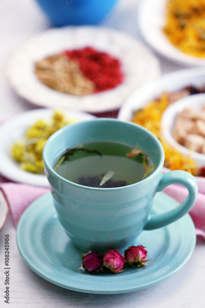 Cup of tea with aromatic dry tea on wooden background Cup of tea with aromatic dry tea on wooden background