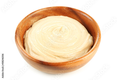 Wooden bowl of tasty hummus, isolated on white