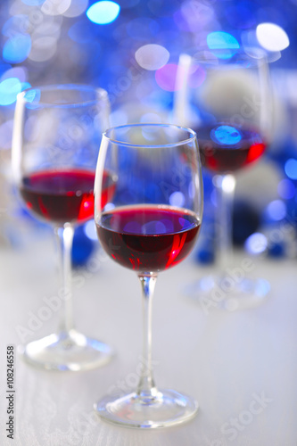 Wineglasses on blue blurred lights background